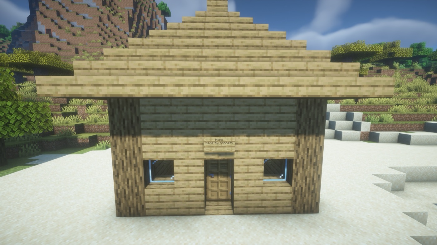 A stone cottage with glass windows built by Claude through Ashlar